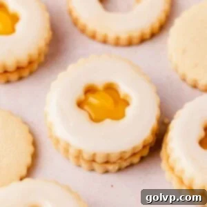 lemon curd filled cut out lemon shortbread cookies shaped like flowers