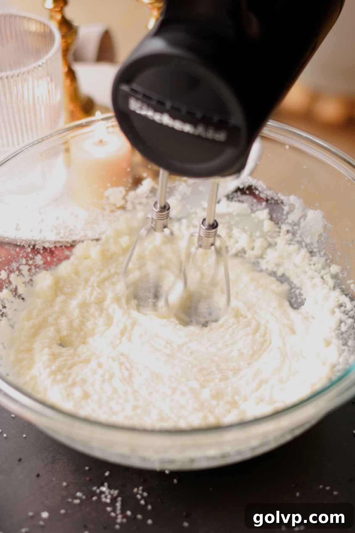 Butter, oil, and sugar being beaten together in a stand mixer until light and fluffy.