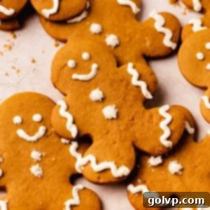 Beautifully decorated gingerbread men cookies with white buttercream frosting