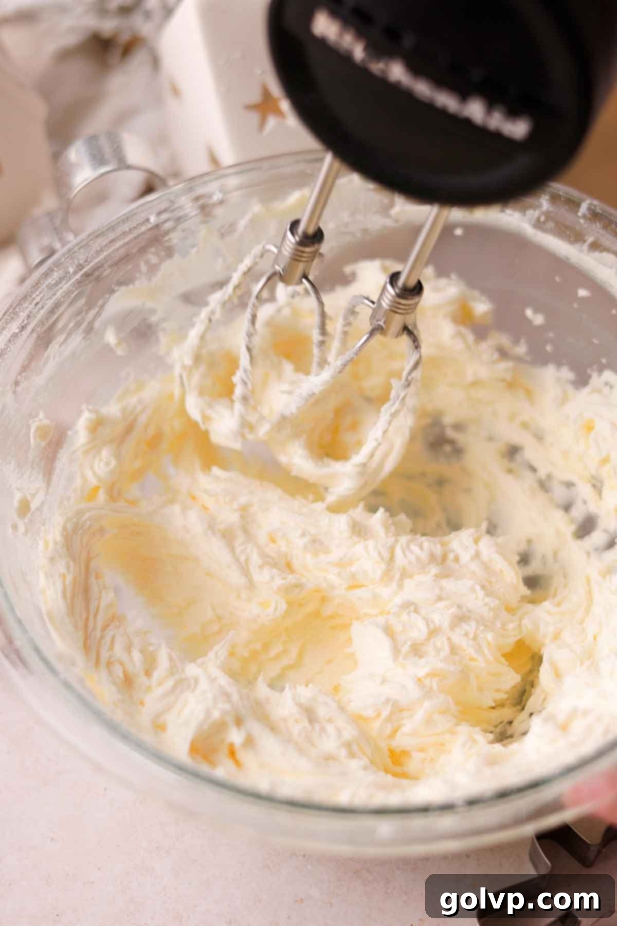 beating butter and sugar together with an electric mixer for buttercream