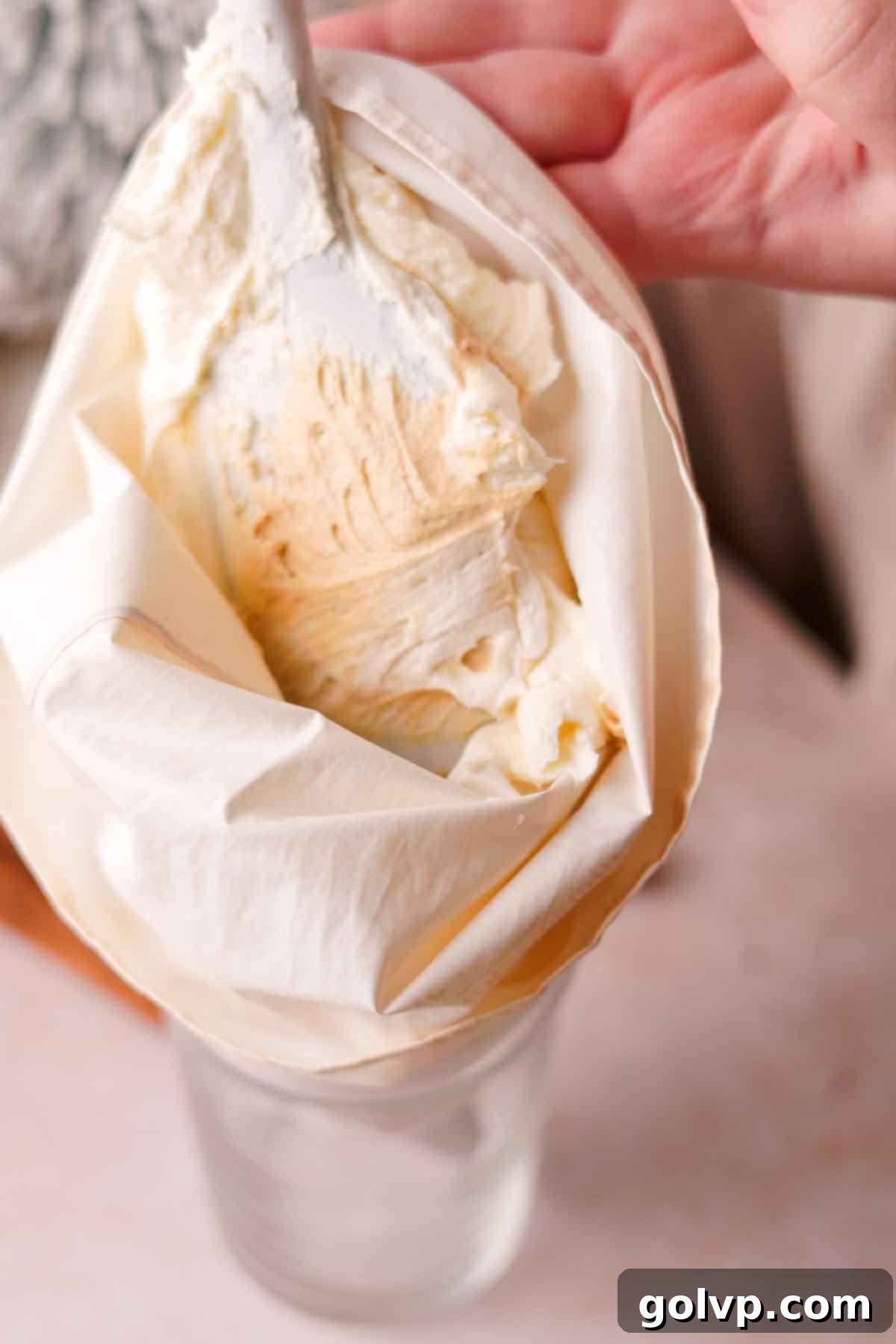 filling piping bag with frosting
