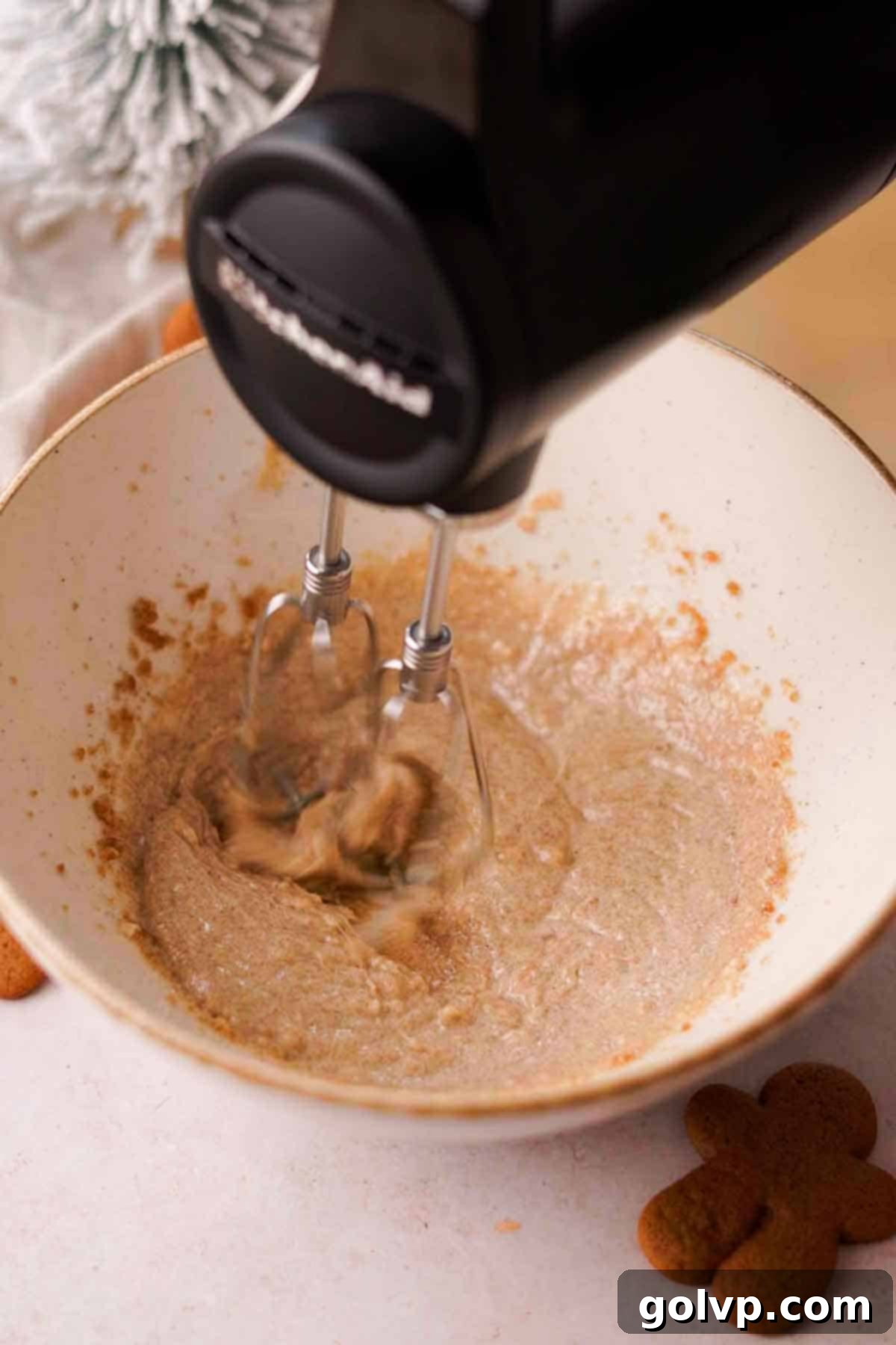 beating sugar, oil, and butter with a handheld stand mixer