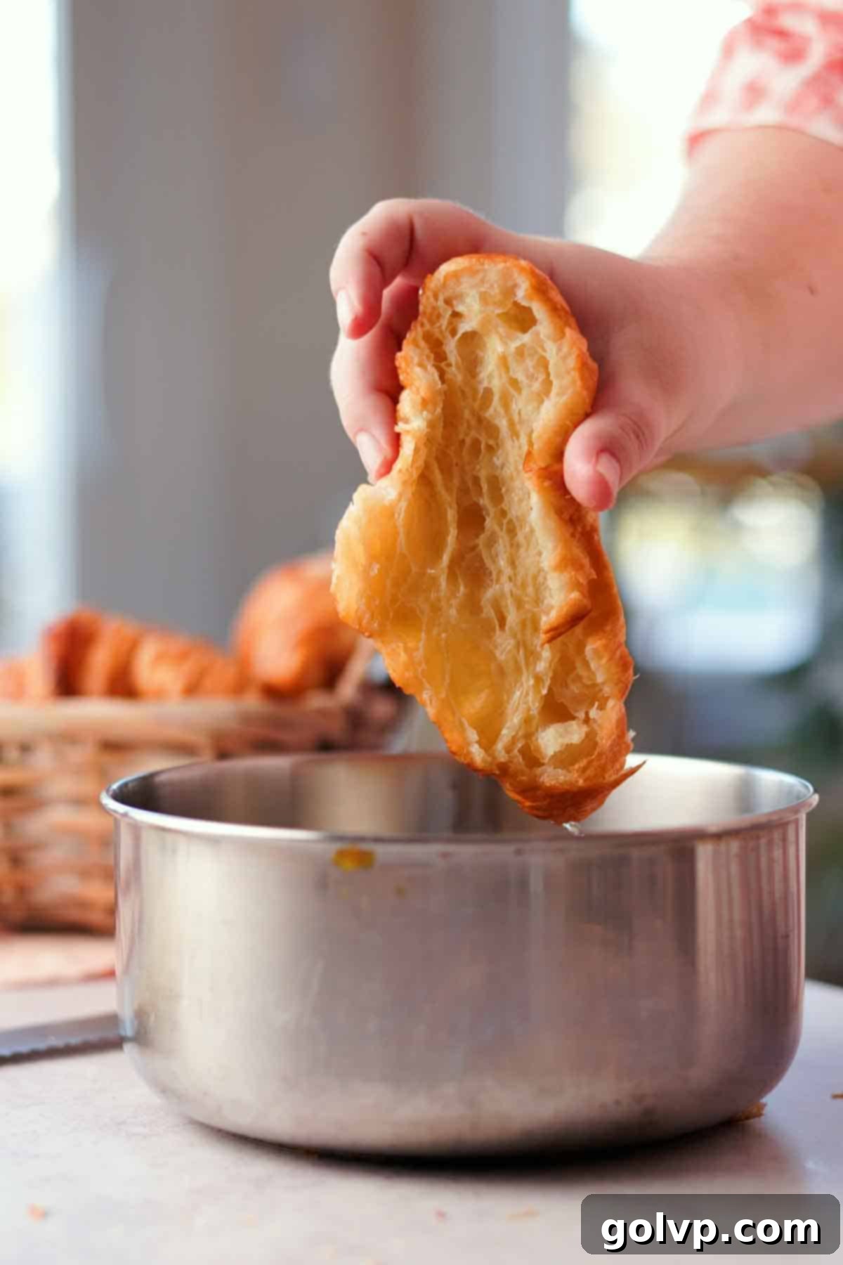 dipping croissants cut in half into syrup