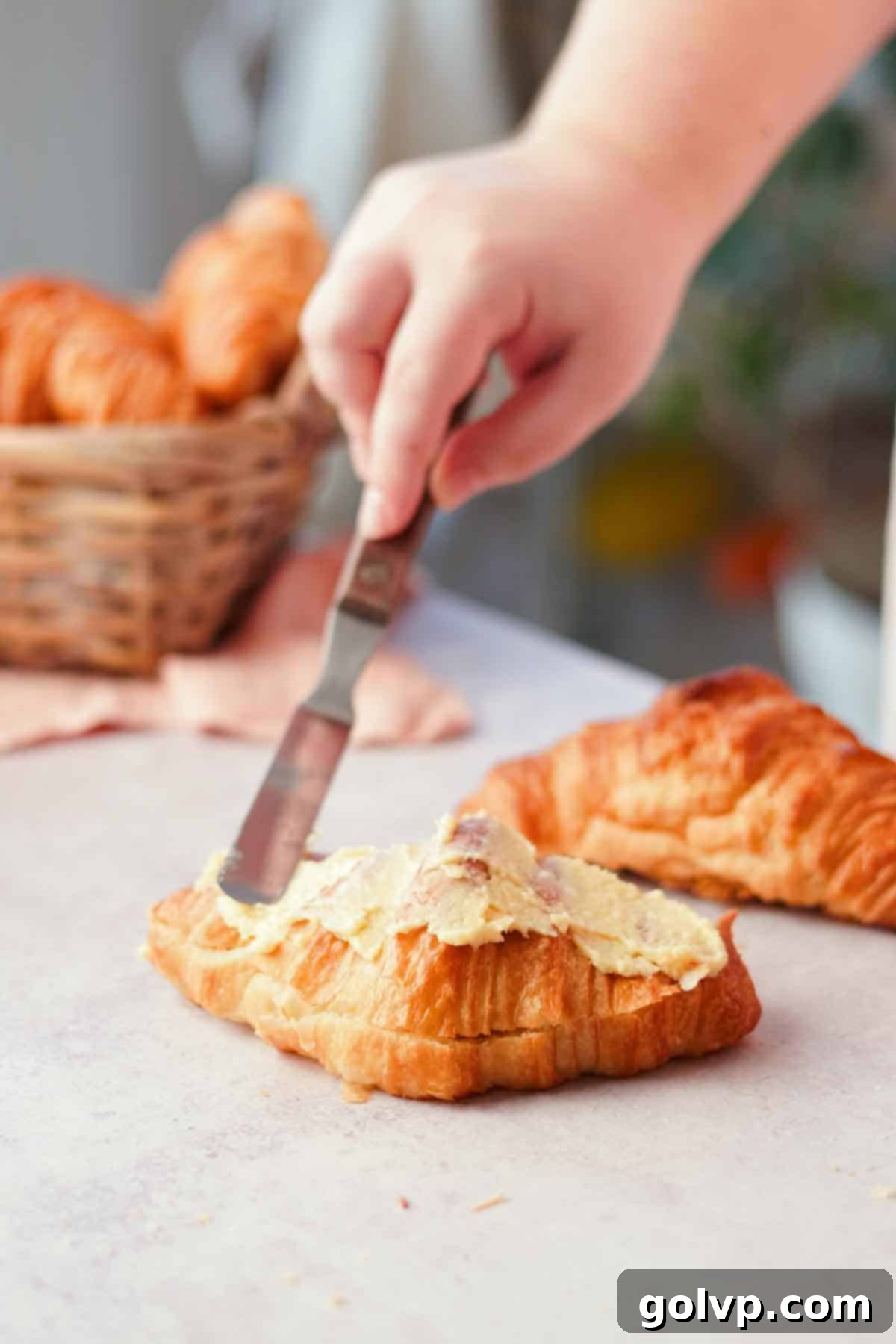spreading filling on top of croissants