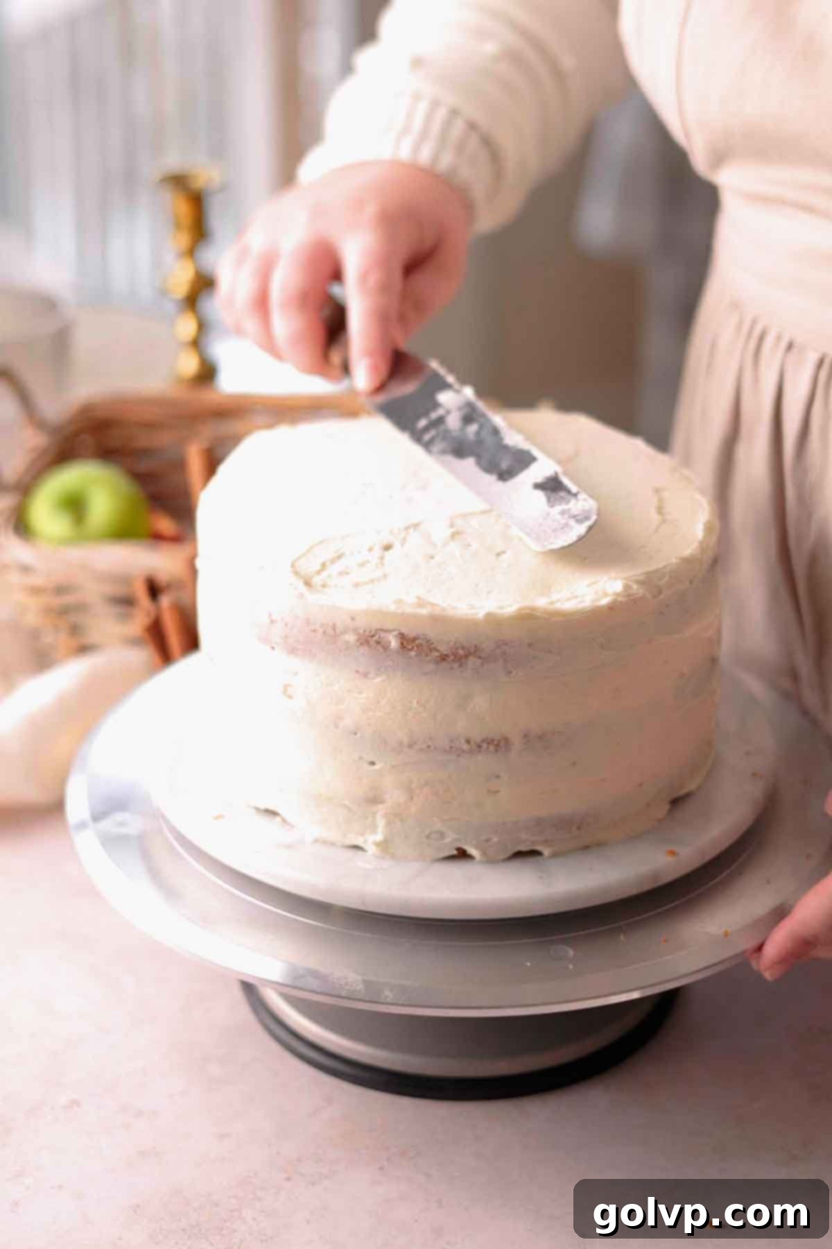 covering cake with frosting