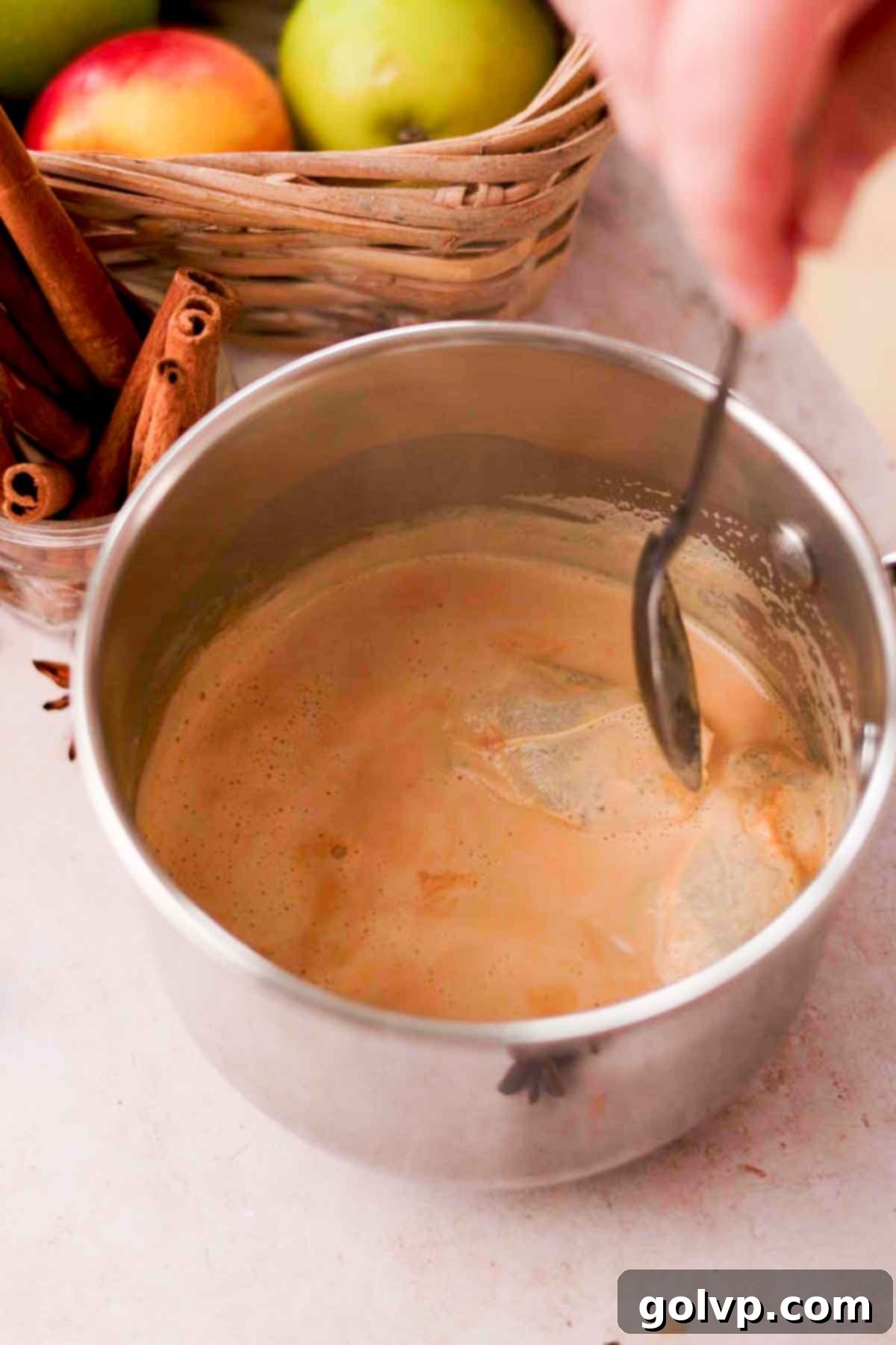 steeping black teabags in milk in small saucepan