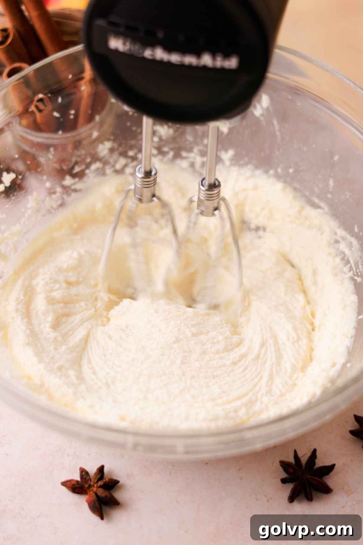 cream butter, oil, and sugar for cake in a large glass bowl with electric mixer