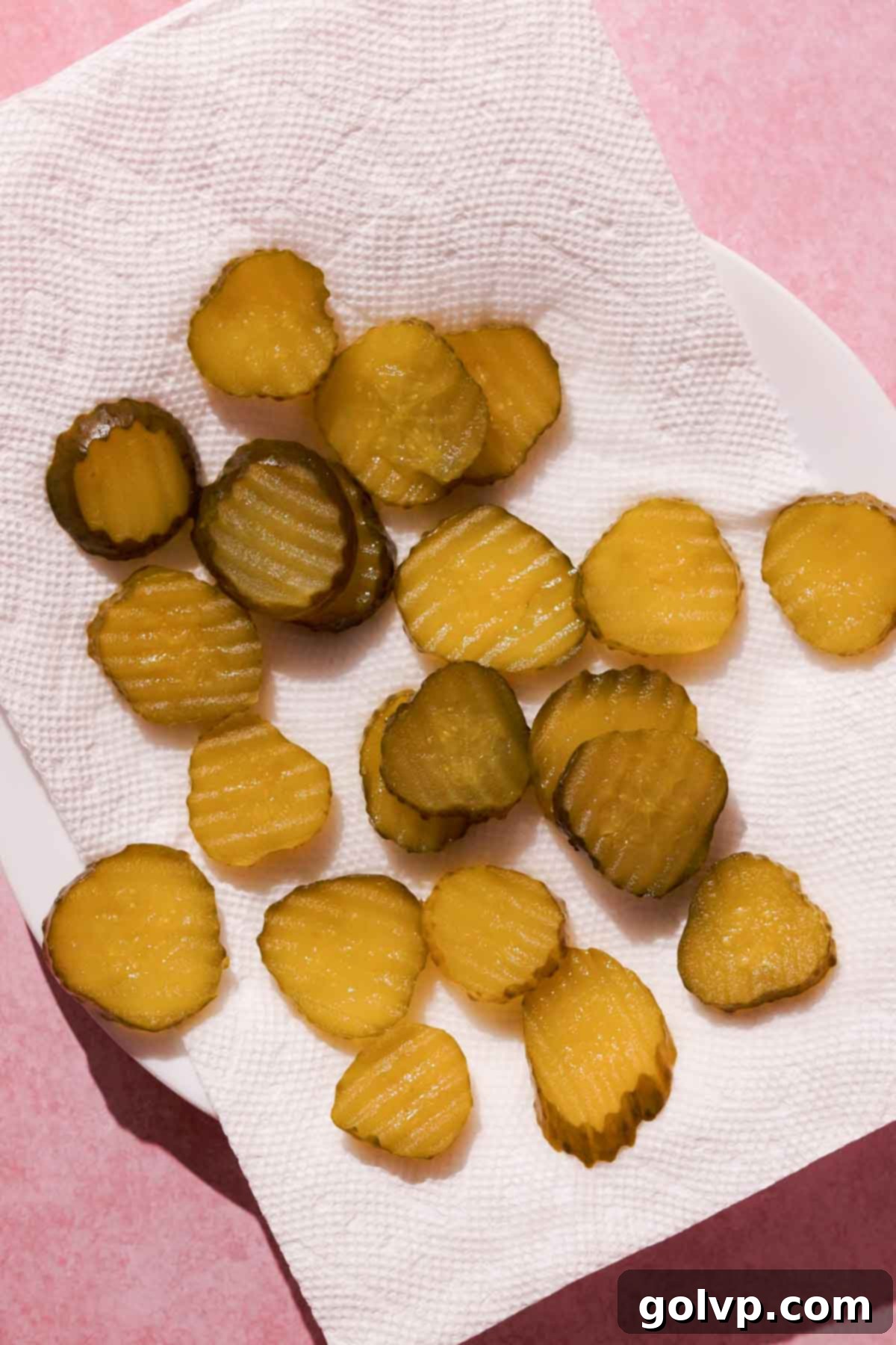 pickle slices on a plate covered with paper towel