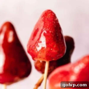 Close-up of a strawberry Tanghulu on a stick, showcasing its glistening, hard candy coating
