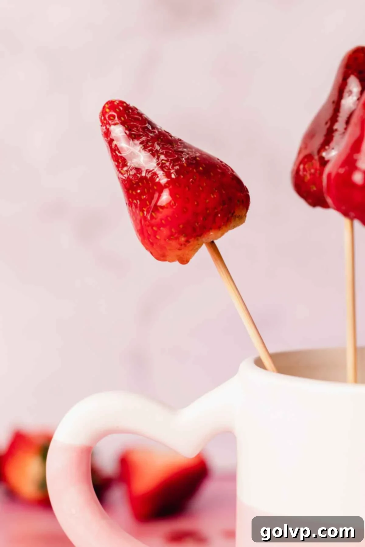 A perfectly set strawberry Tanghulu on a skewer, with a clear, glossy sugar coating, ready to eat