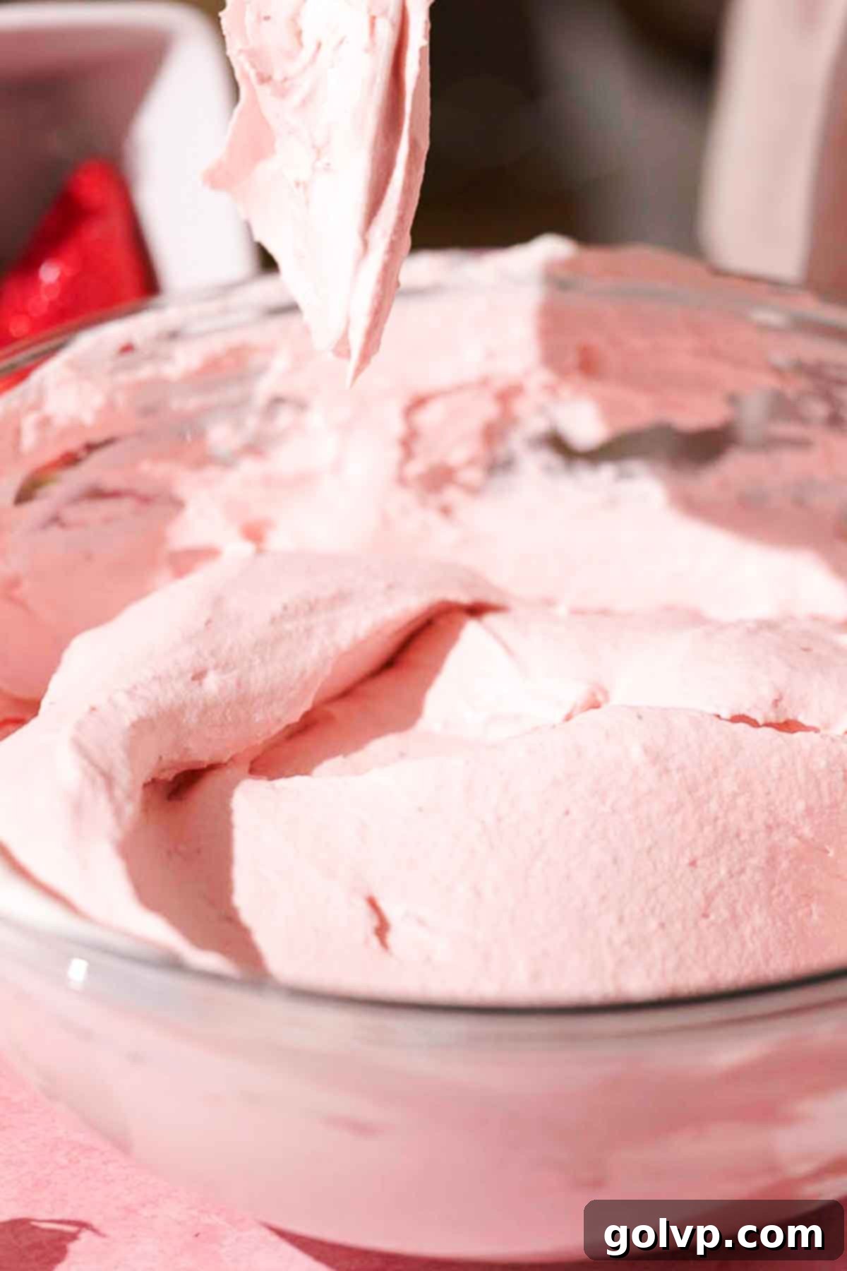 folding whipped cream and strawberry mascarpone mixture to form filling