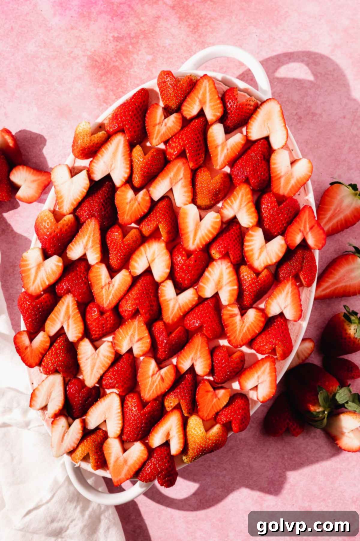 strawberry tiramisu in casserole dish topped with strawberry halves cut into hearts