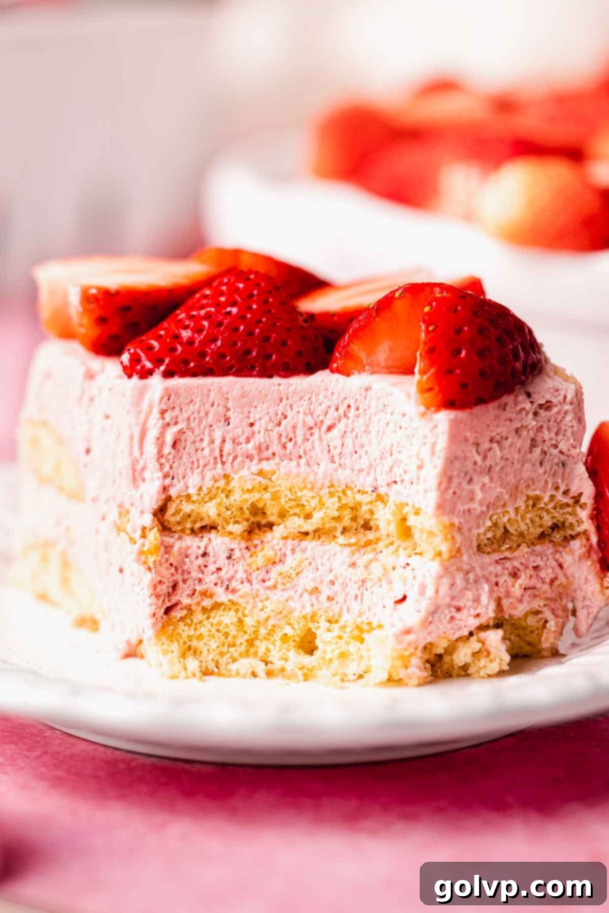 slice of strawberry tiramisu with bite taken out of