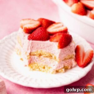 sliced strawberry tiramisu on plate with fresh strawberries on top square