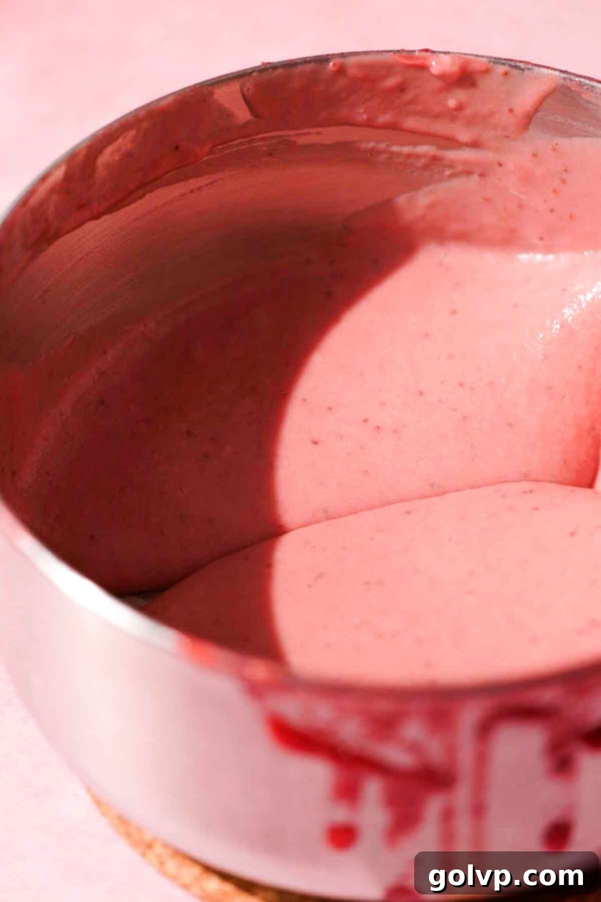 stirring prepared strawberry curd in saucepan to show texture