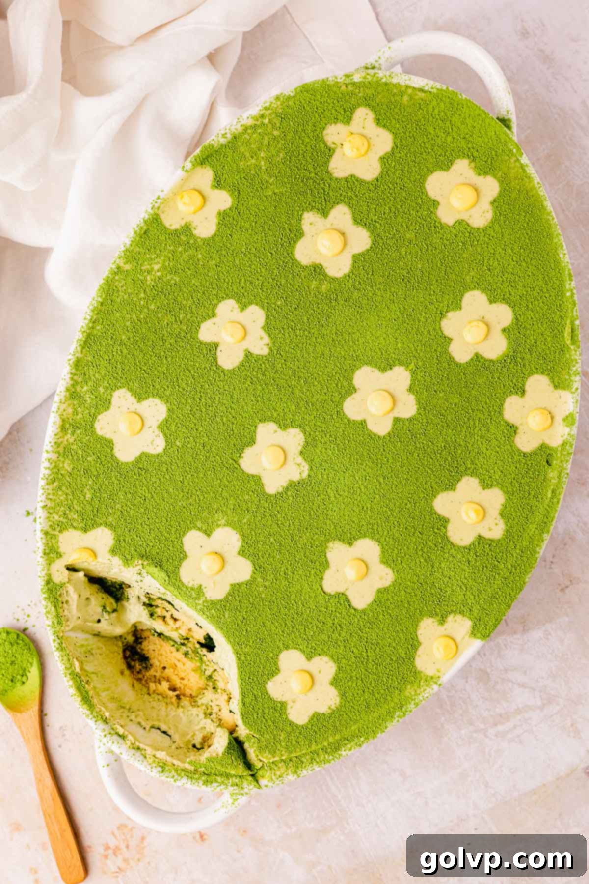beautifully decorated matcha tiramisu with edible flower accents