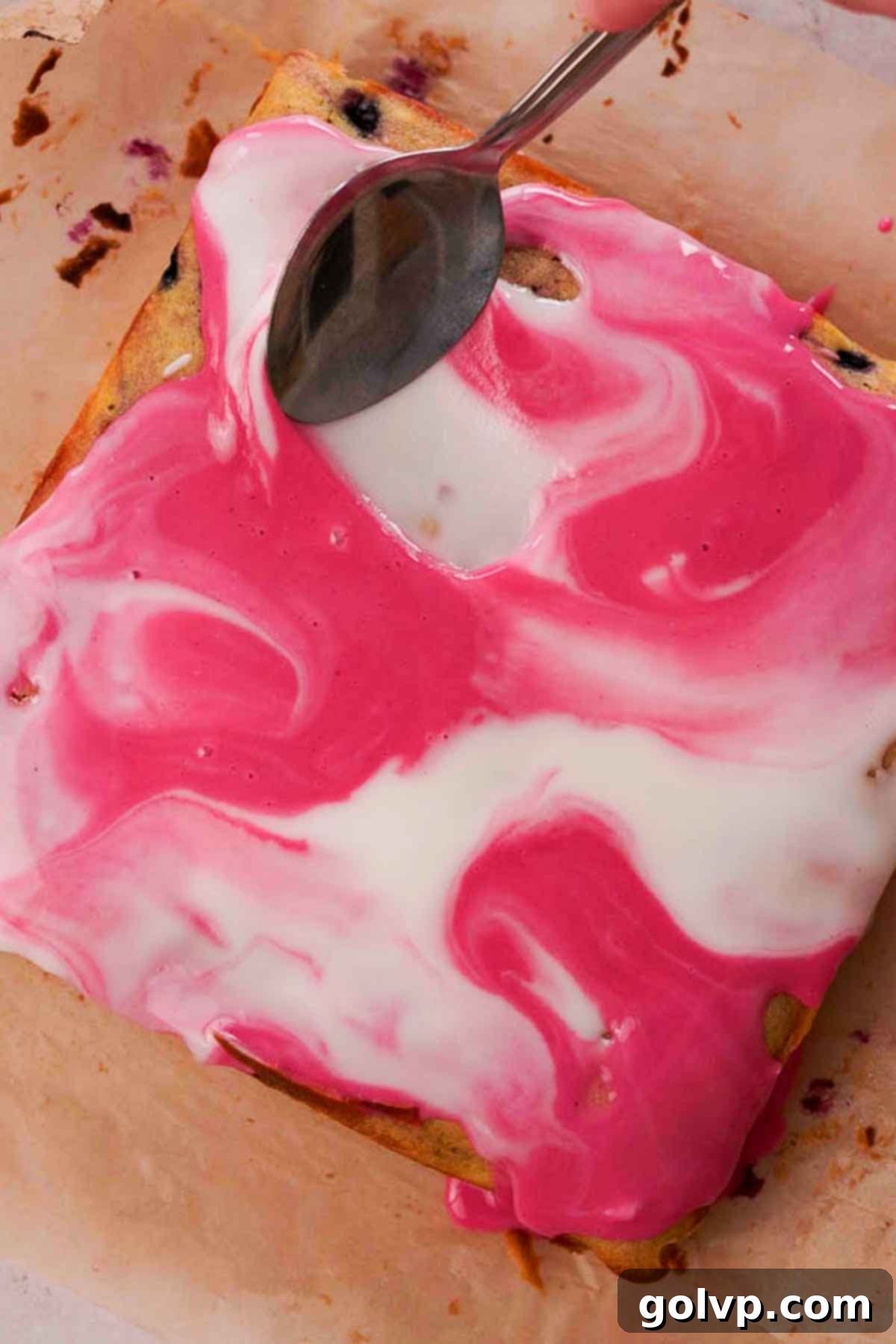 Swirling purple blueberry and white lemon glazes together on the cooled blueberry brownies to create a beautiful marbled effect