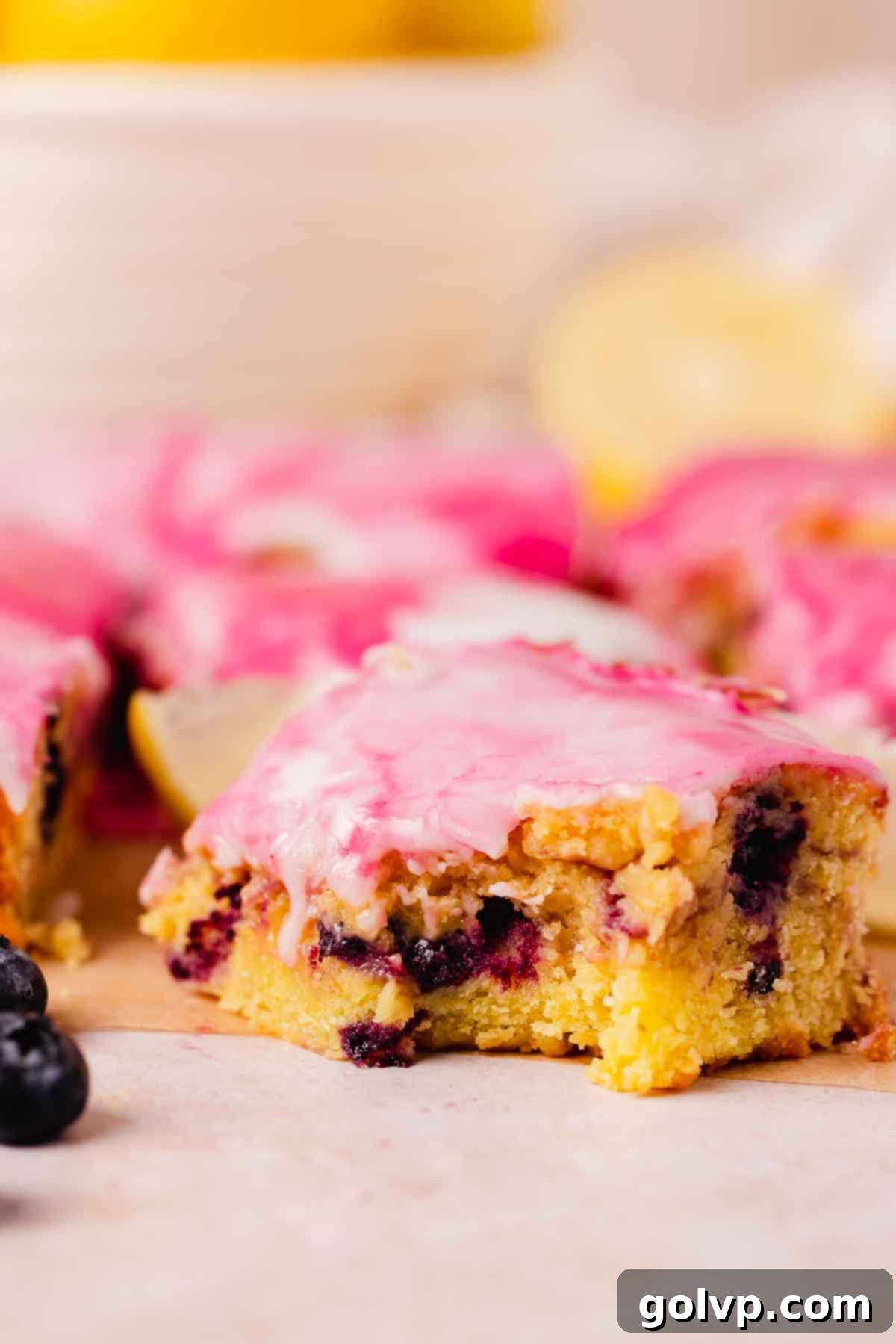 Extreme close-up of the fudgy texture of a blueberry lemon brownie, revealing the dense, moist crumb and visible blueberry pieces