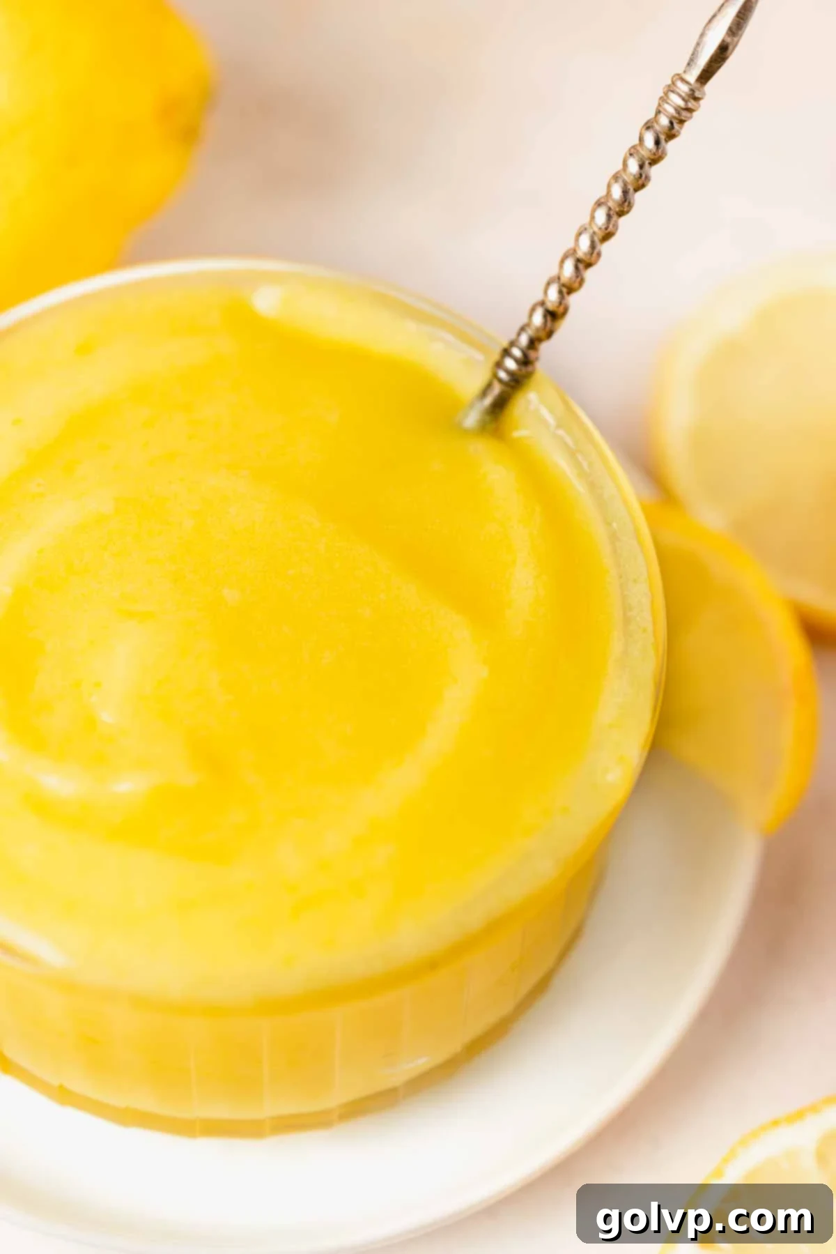 closeup of lemon curd texture in bowl with spoon