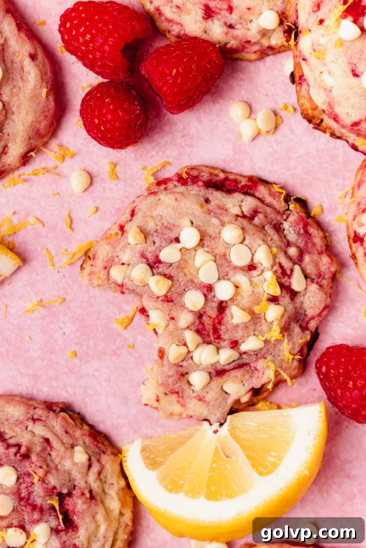 Beautifully swirled lemon raspberry cookies topped with perfectly melted white chocolate chips and fresh grated lemon zest