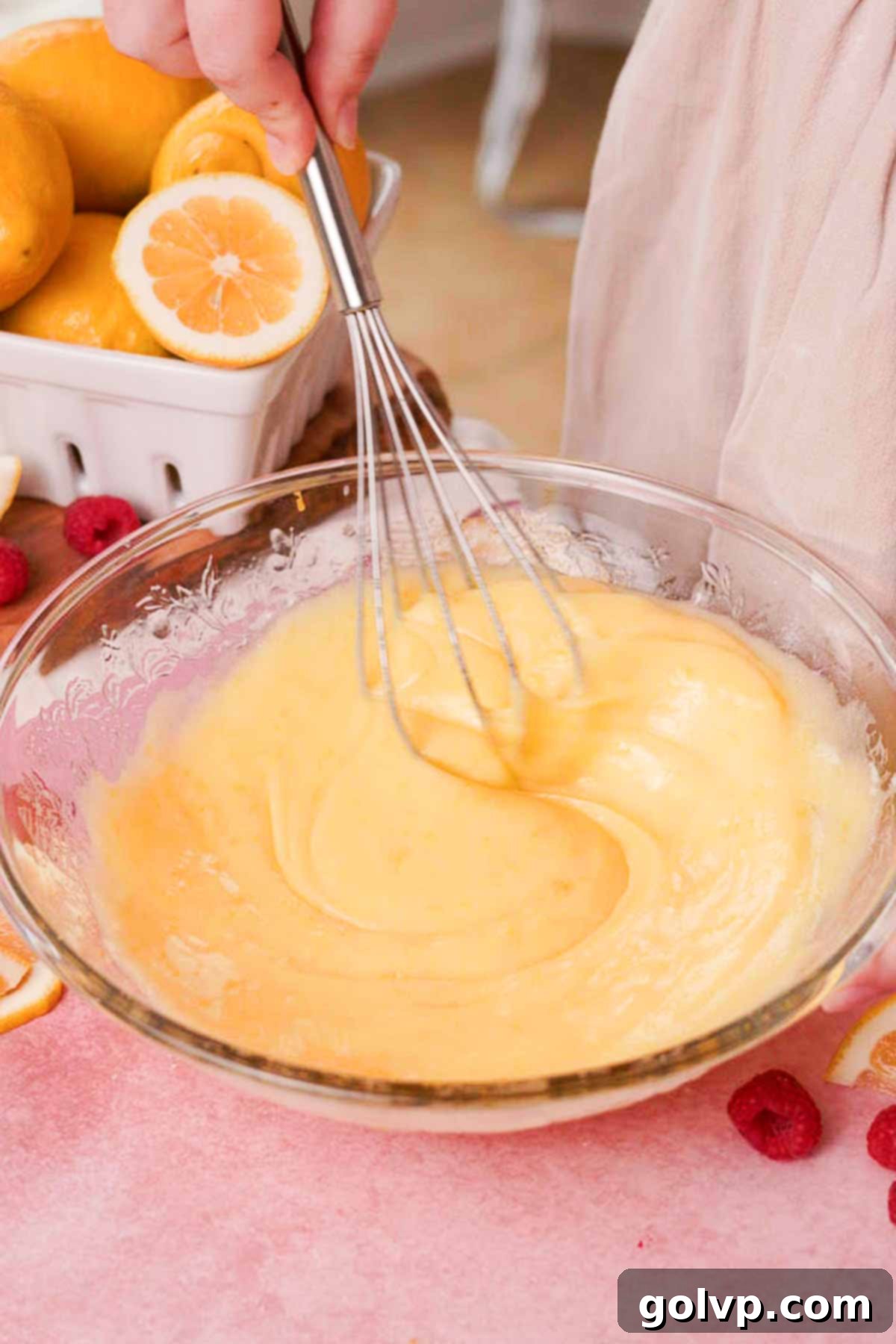 Whisking room temperature melted butter into the combined wet cookie dough ingredients in a large glass bowl until smooth