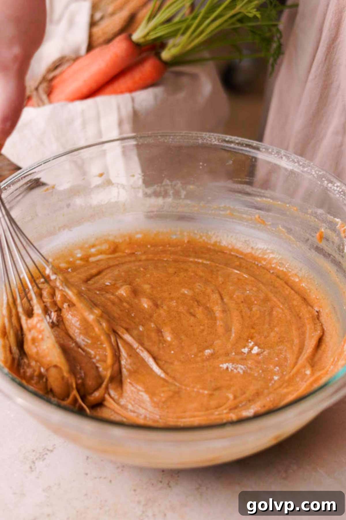 folding carrot cake batter with whisk