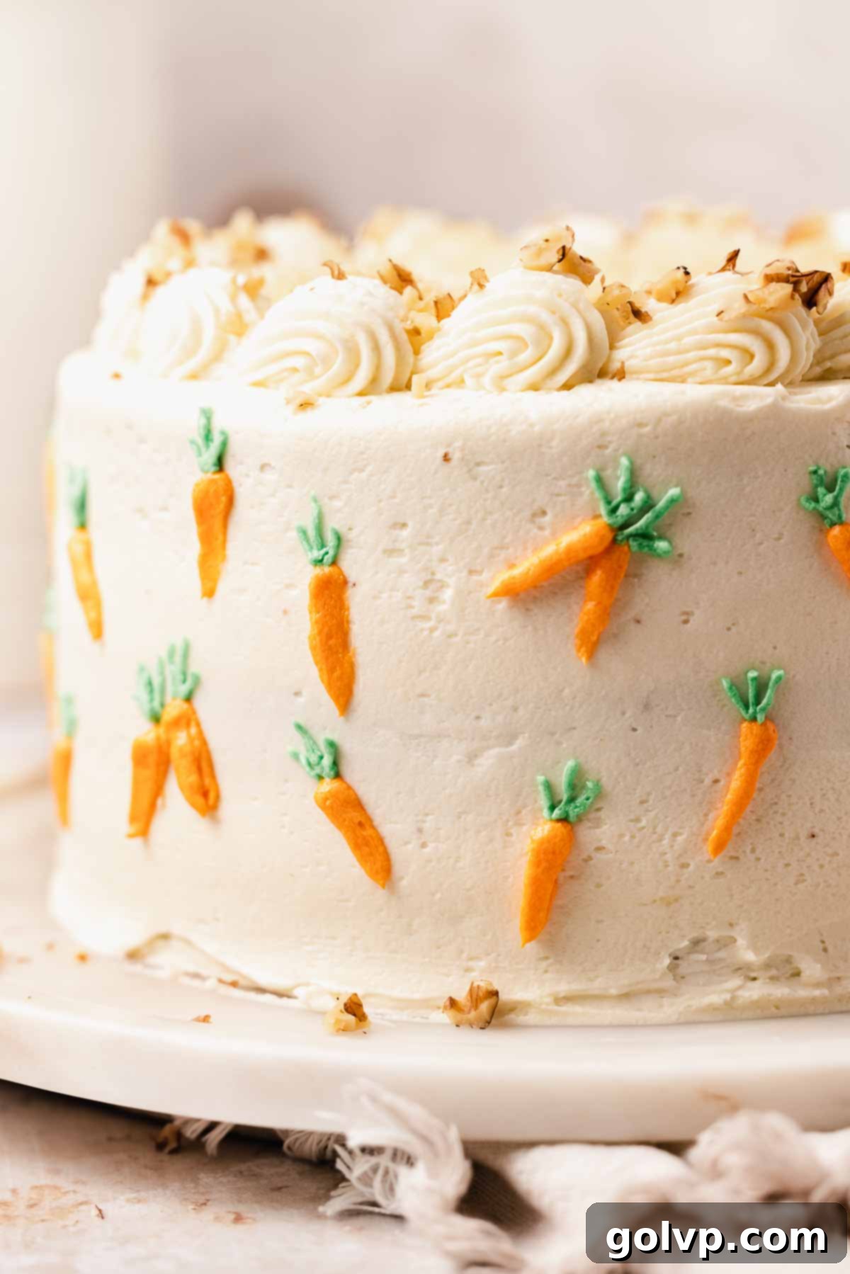 closeup of mini carrots piped on the outside of carrot cake