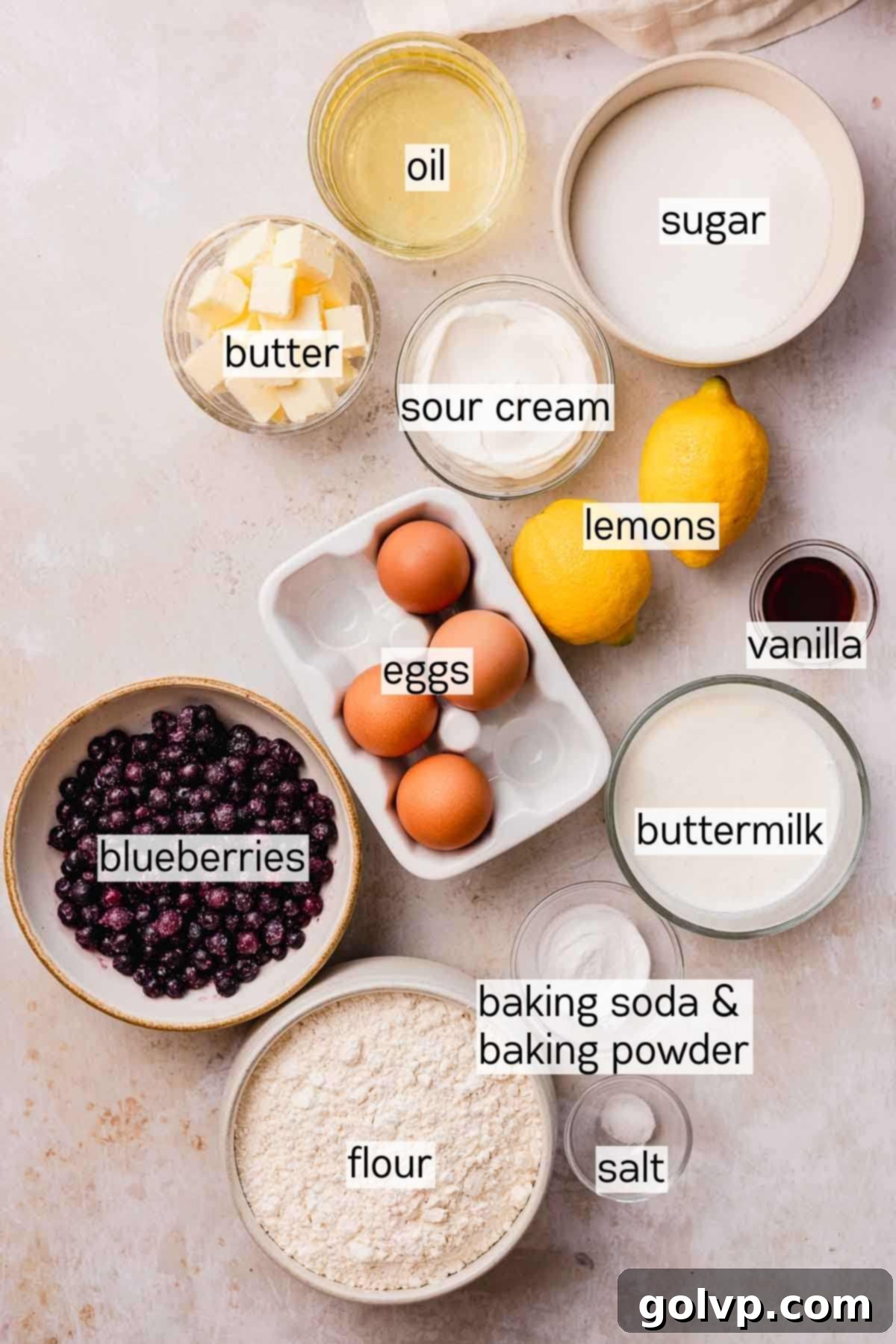 Bowls of ingredients for the cake layers: butter, oil, flour, sugar, eggs, buttermilk, sour cream, and lemons.