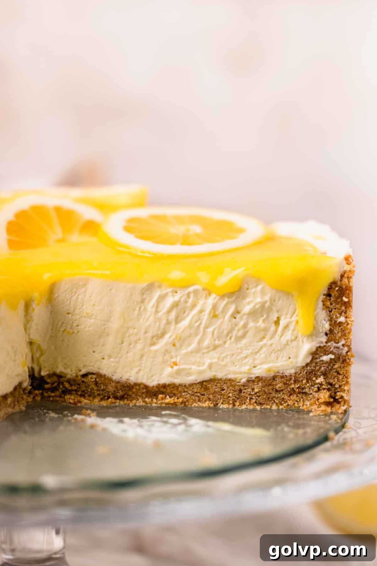 sliced lemon cheesecake to show creamy texture and lemon curd drip