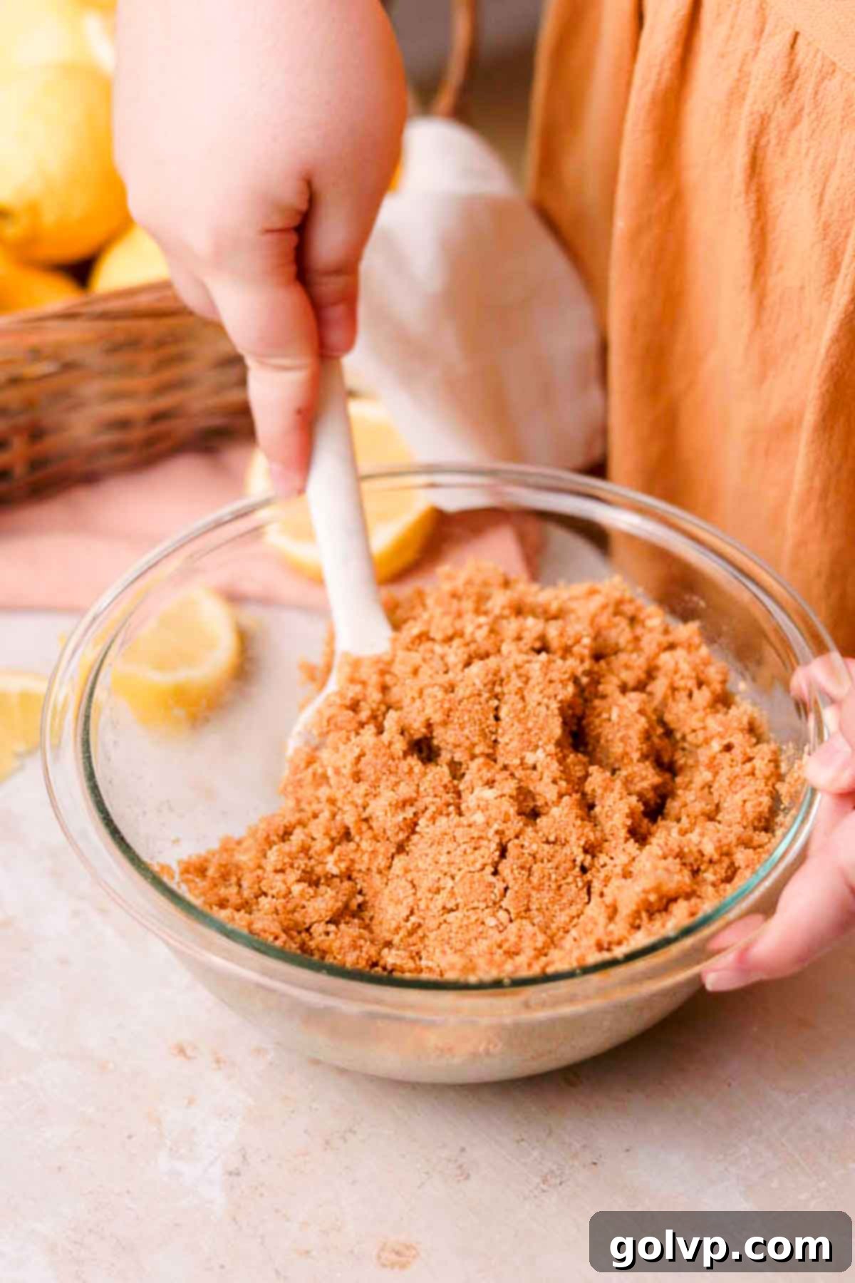 mix graham cracker crust in a glass bowl with a silicone spatula