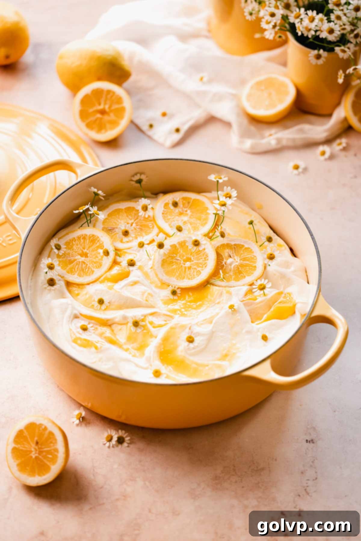 A beautifully decorated lemon poke cake in a rustic pot, showcasing its moist texture and rich lemon color.