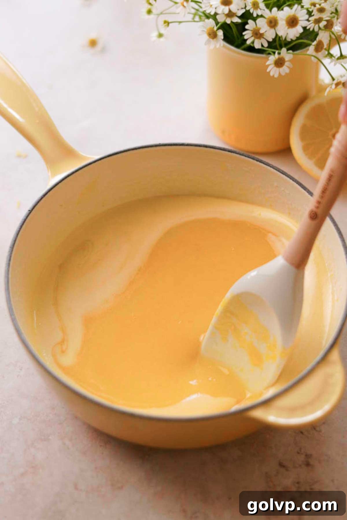 The vibrant yellow lemon curd mixture, ready to be cooked in a pot on the stovetop.