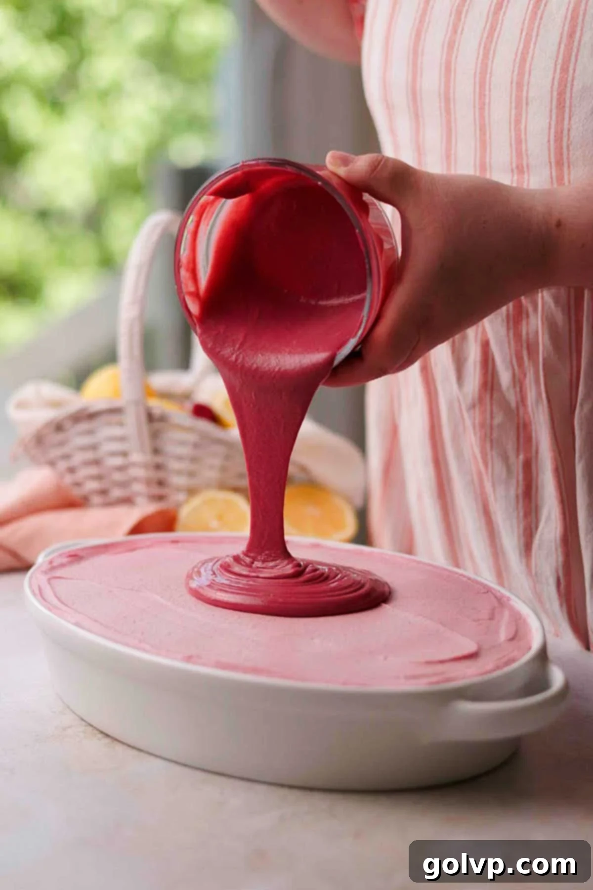 pouring raspberry curd over tiramisu