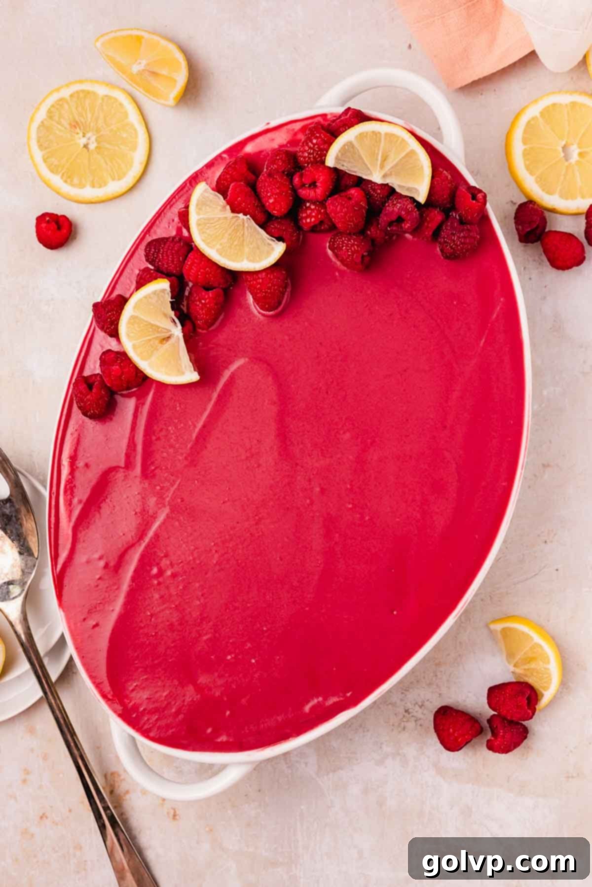 decorated raspberry tiramisu topped with fresh raspberries and lemons