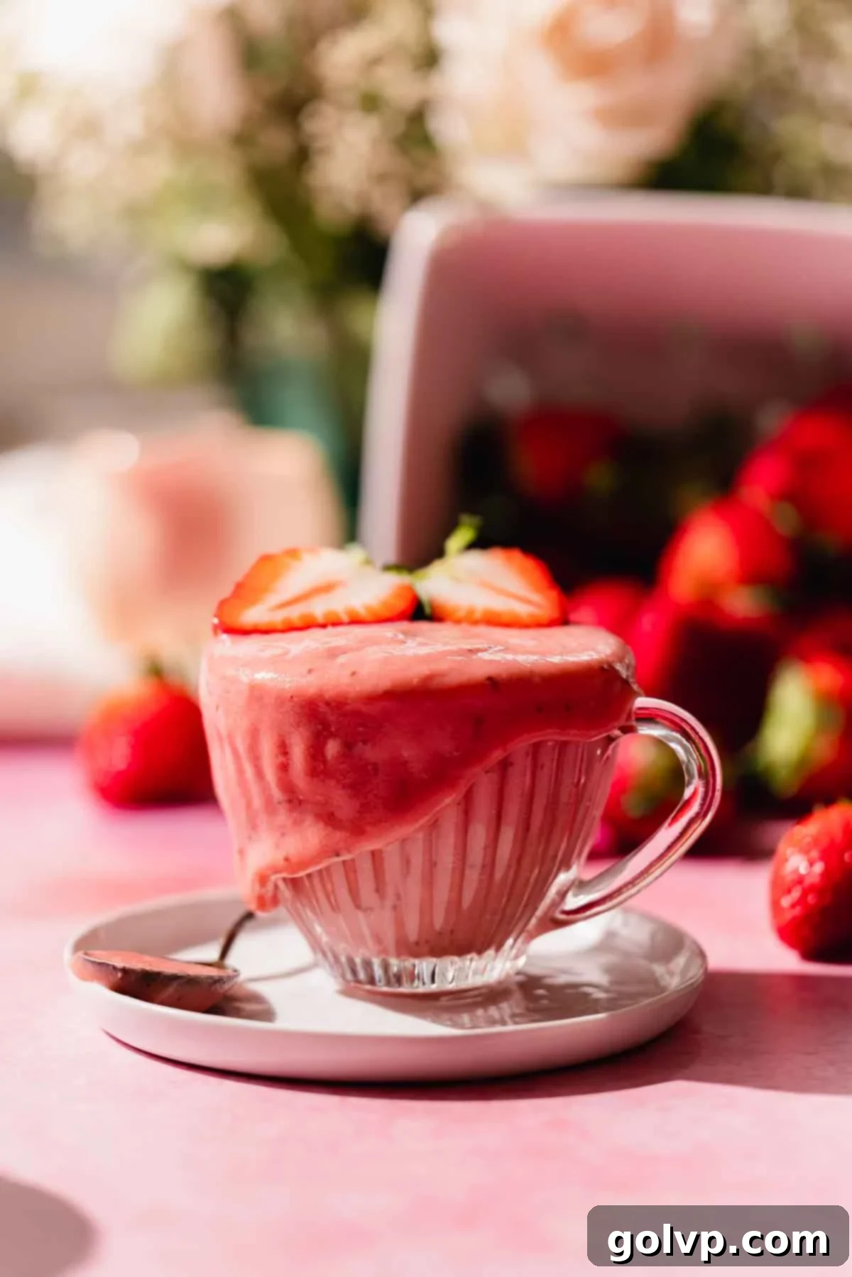 strawberry curd in cup surrounded with fresh strawberries