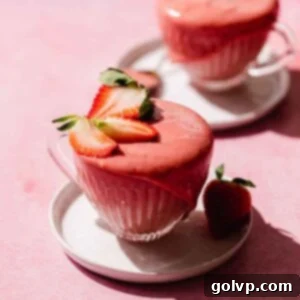 strawberry curd in a cup with fresh strawberries