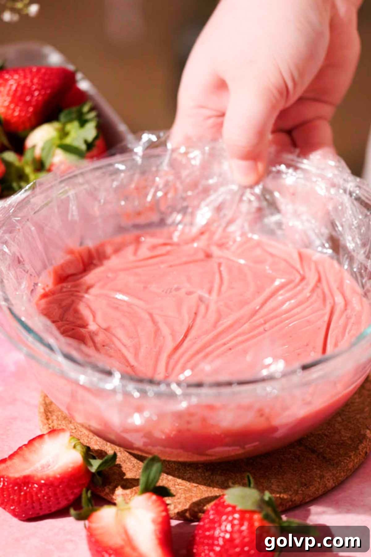 bowl with strawberry curd covered with plastic wrap