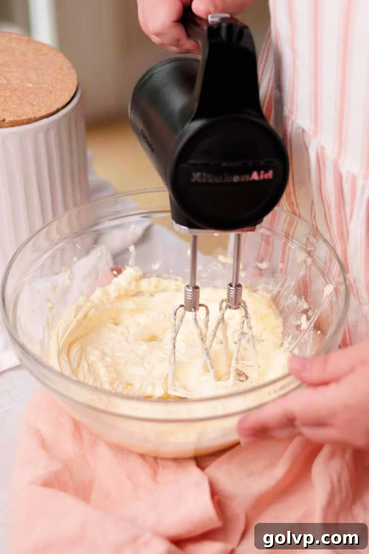 whipping softened butter with electric mixer in large glass bowl