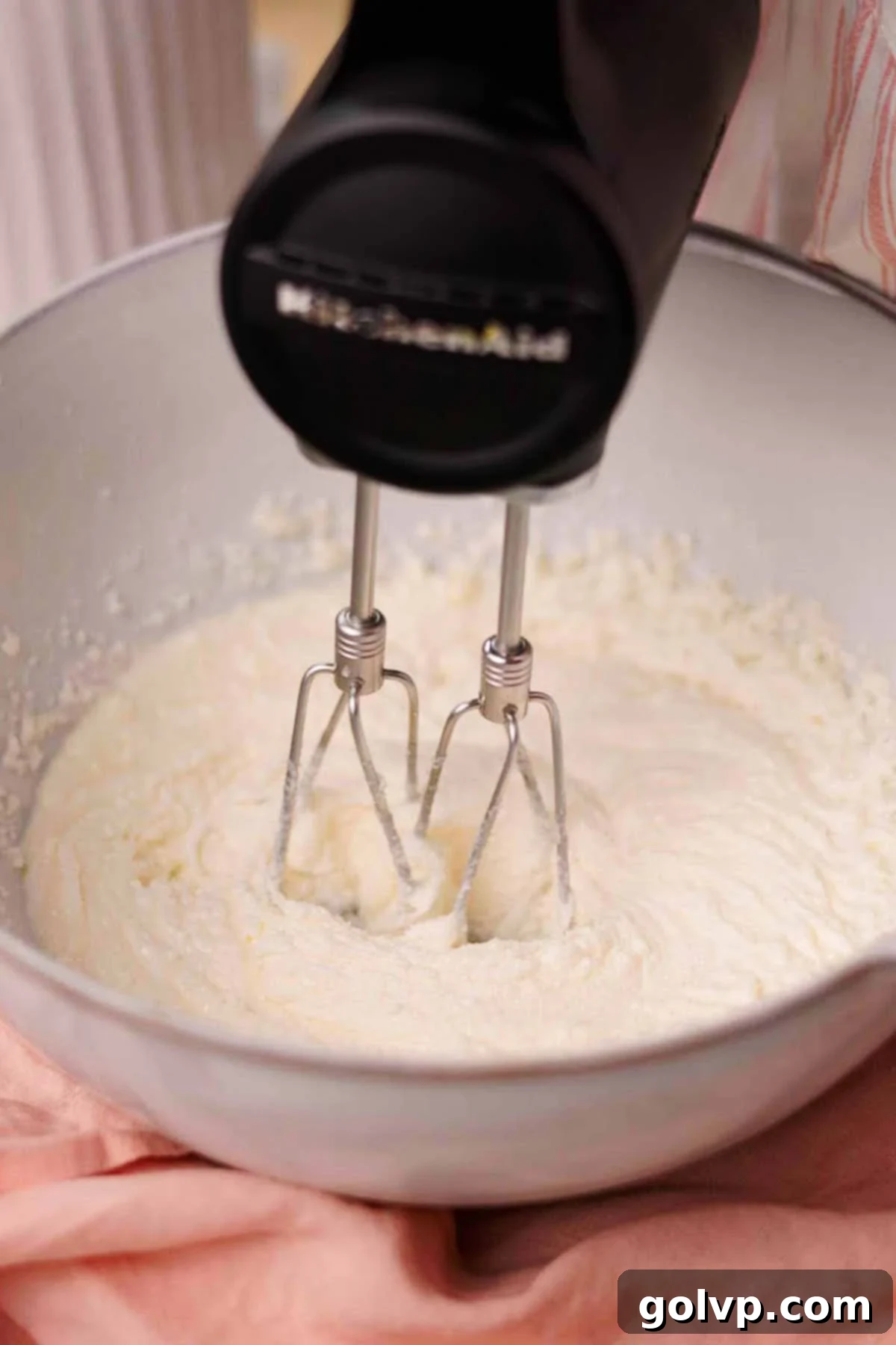 beating butter, oil, and sugar in a large bowl with an electric mixer