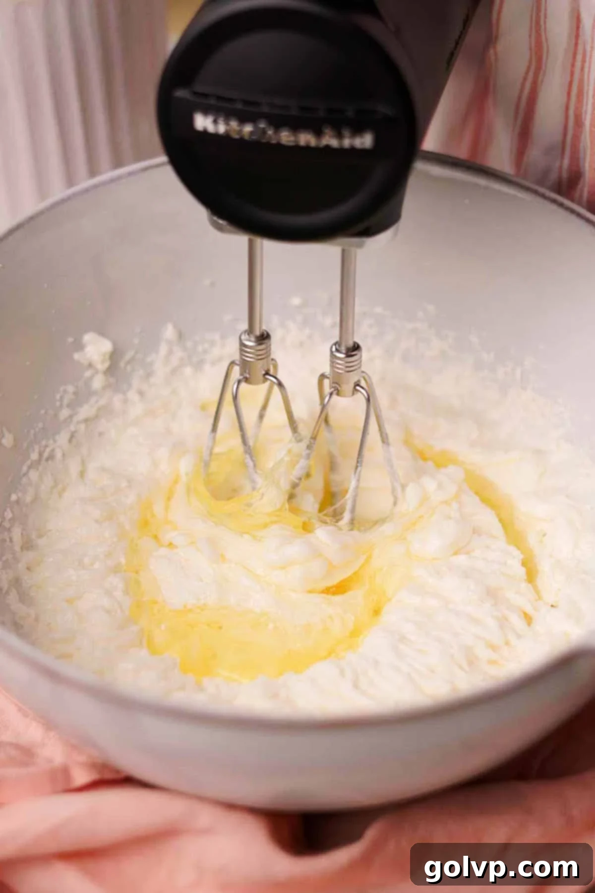 adding egg whites into pink velvet cake batter