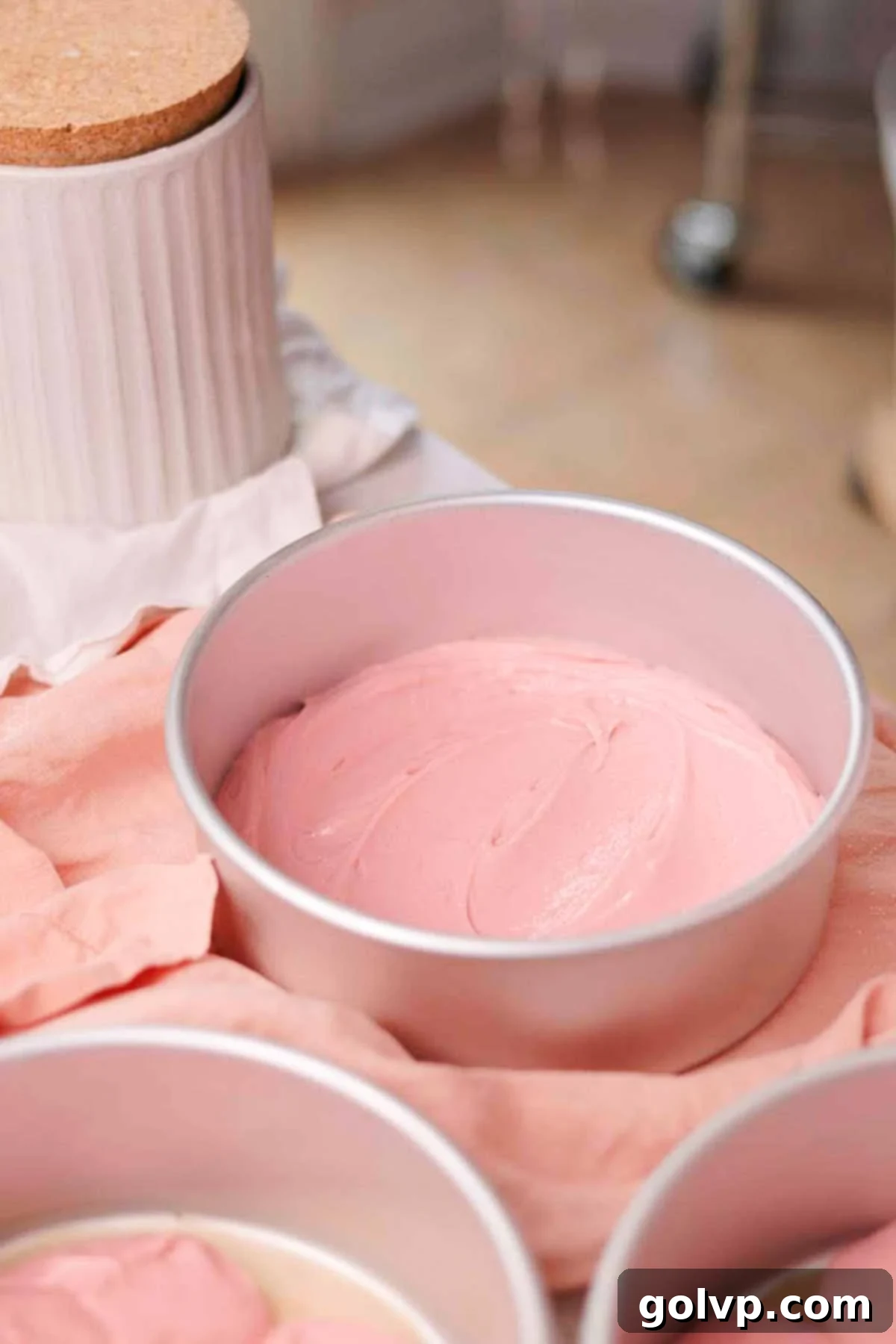 cake batter in baking pans, ready to bake