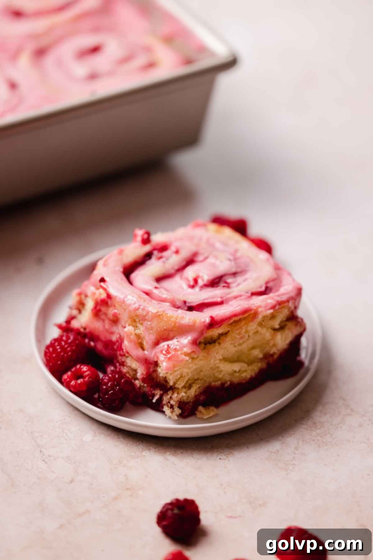 raspberry roll on small plate with fresh raspberries