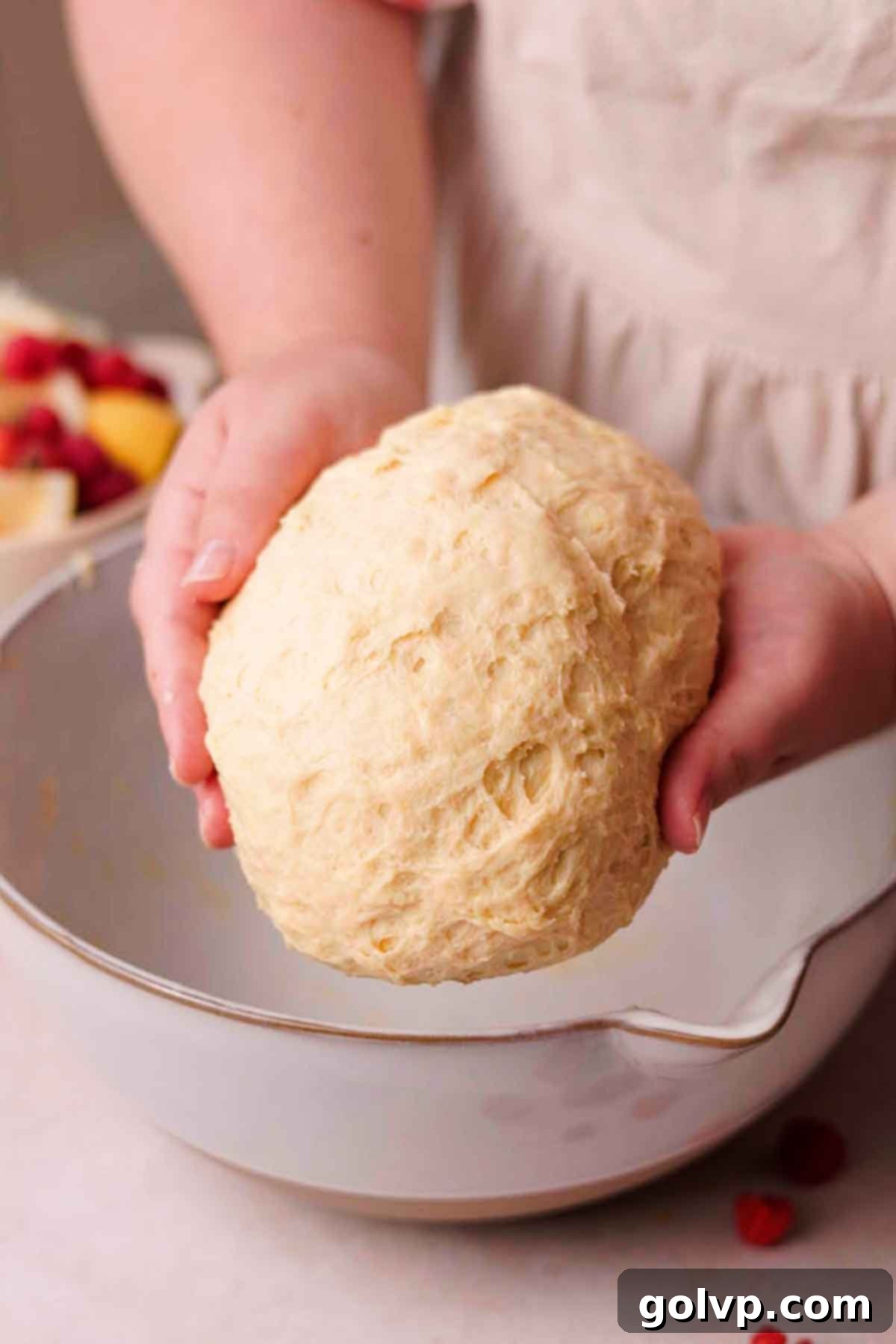 folding risen ball of dough by hand