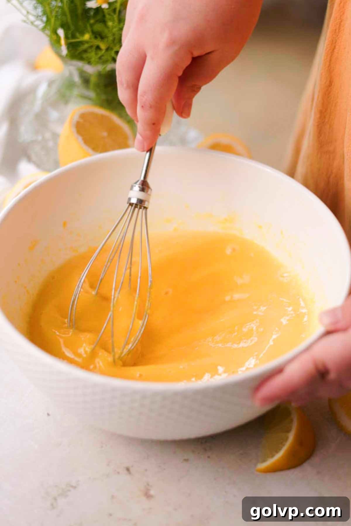whisking lemon filling together for lemon bars