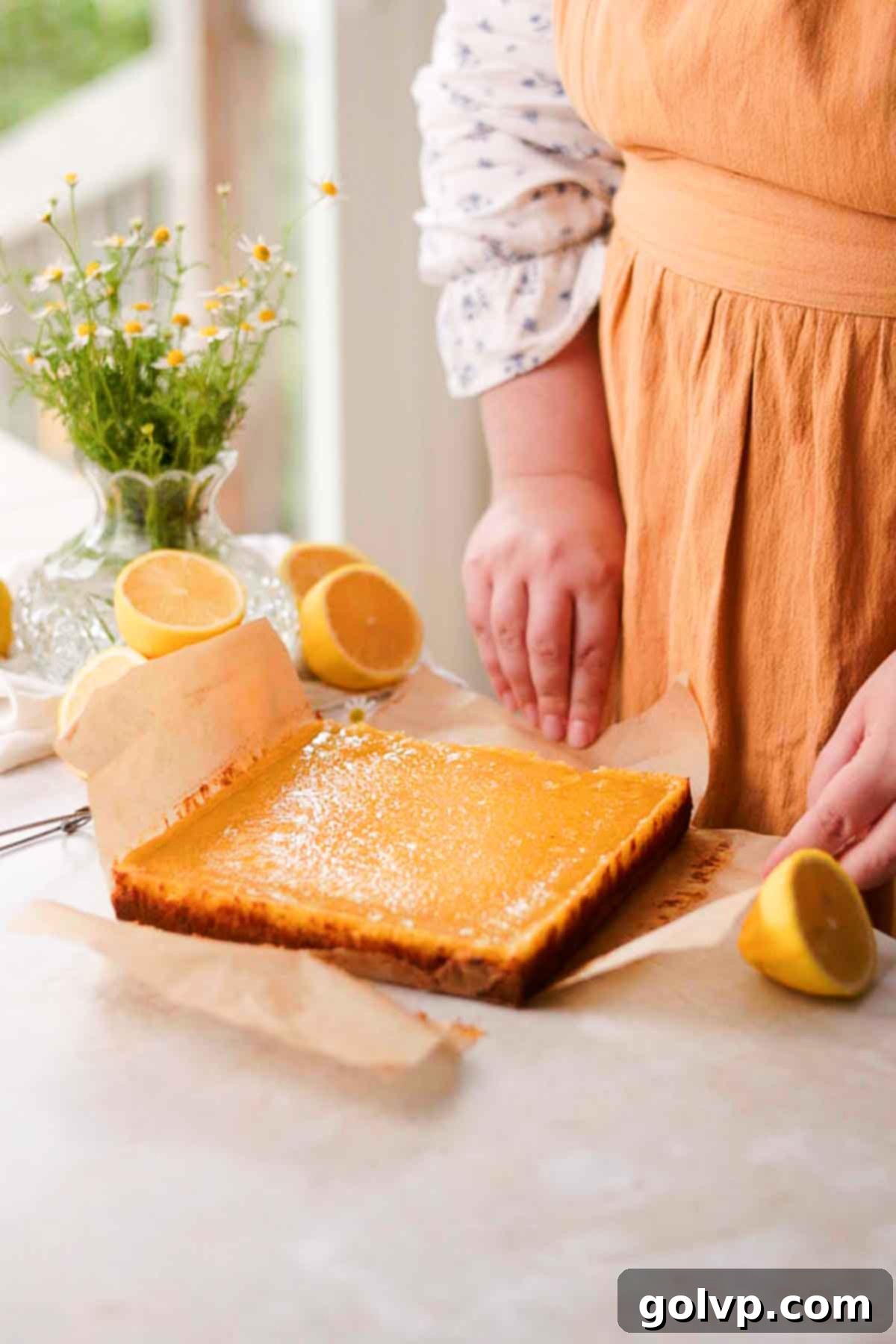 baked and cooled lemon bars on parchment paper