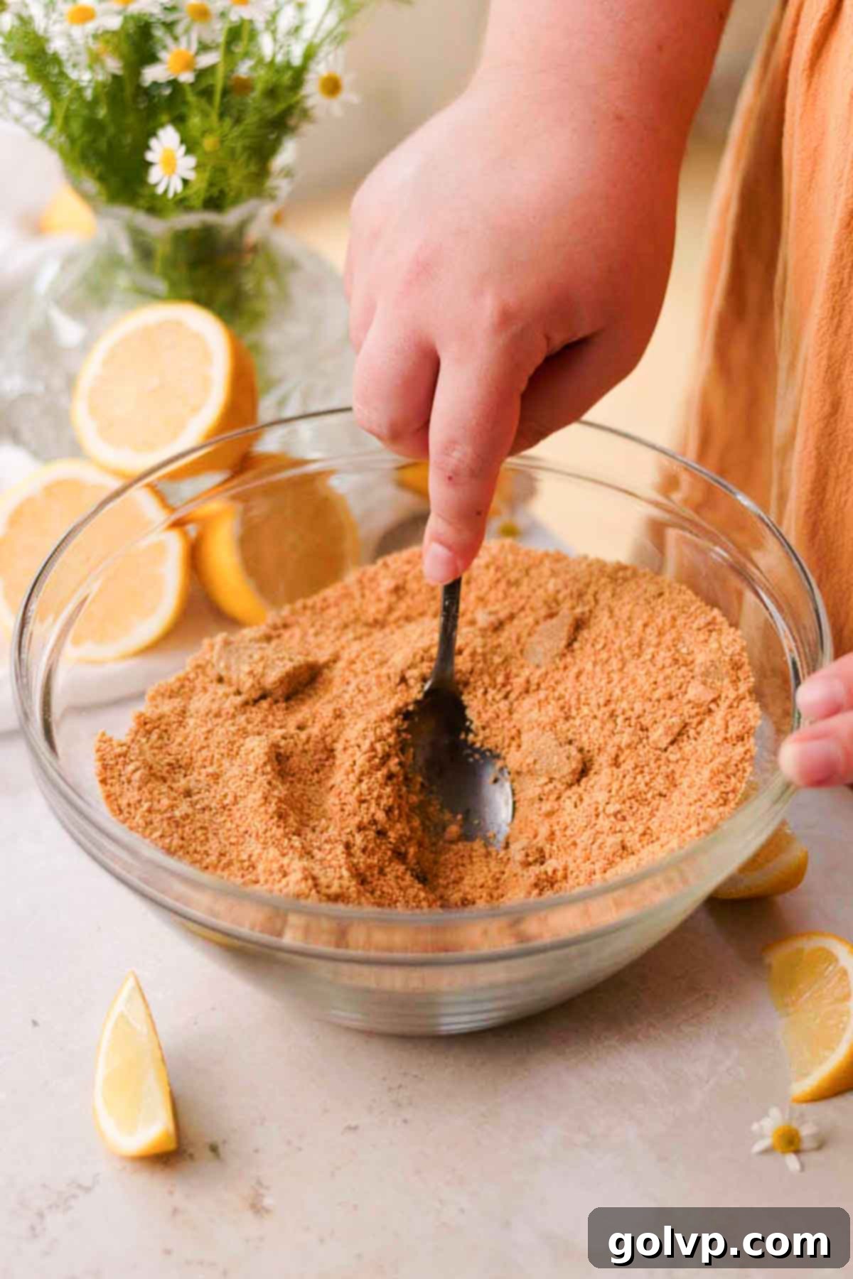 stirring graham crumbs and brown sugar in large bowl with spoon