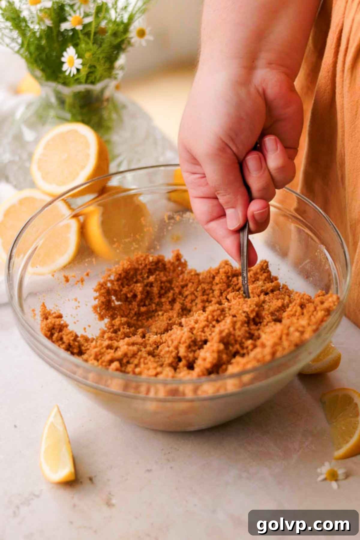 stirring graham cracker crust with a spoon