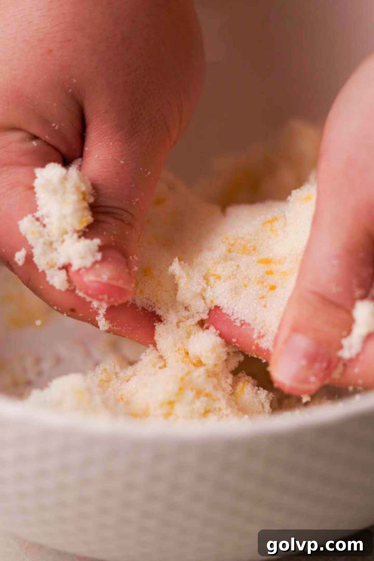 rubbing lemon zest and sugar with fingers
