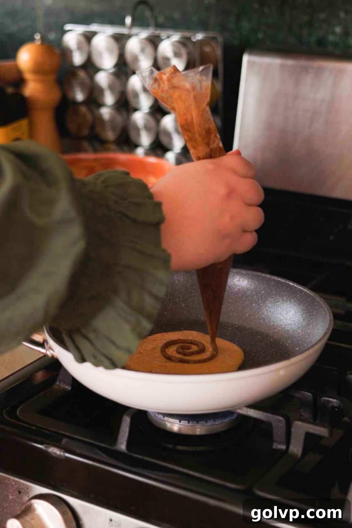 Step 2: Piping pumpkin spice swirl onto cooking pancake