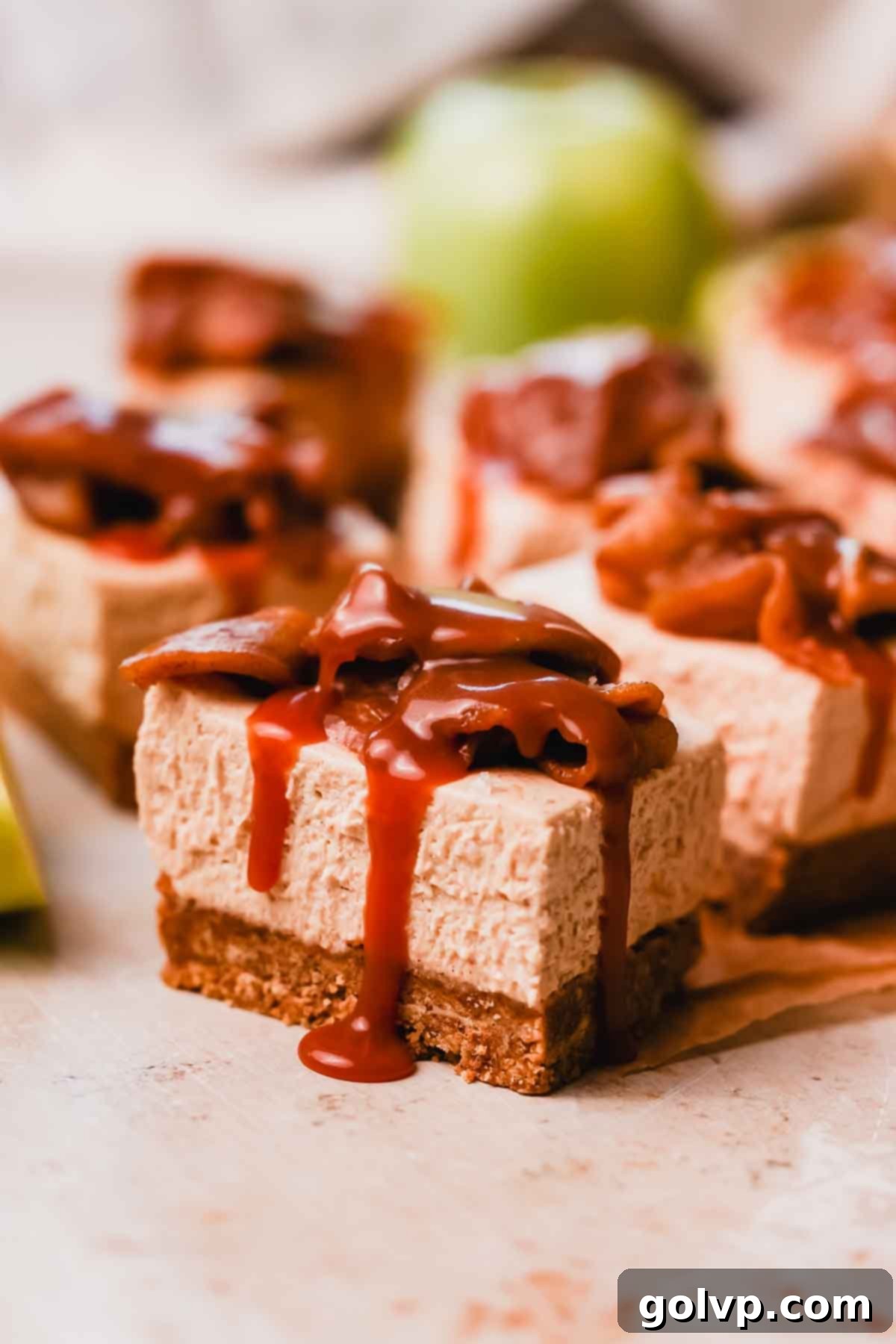 closeup of caramel dripping down the side of a cheesecake bar